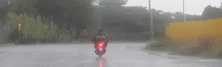 motorcycle rider riding in the pouring rain