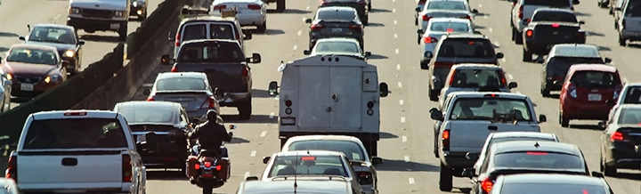 photo of car lined up in highway traffic