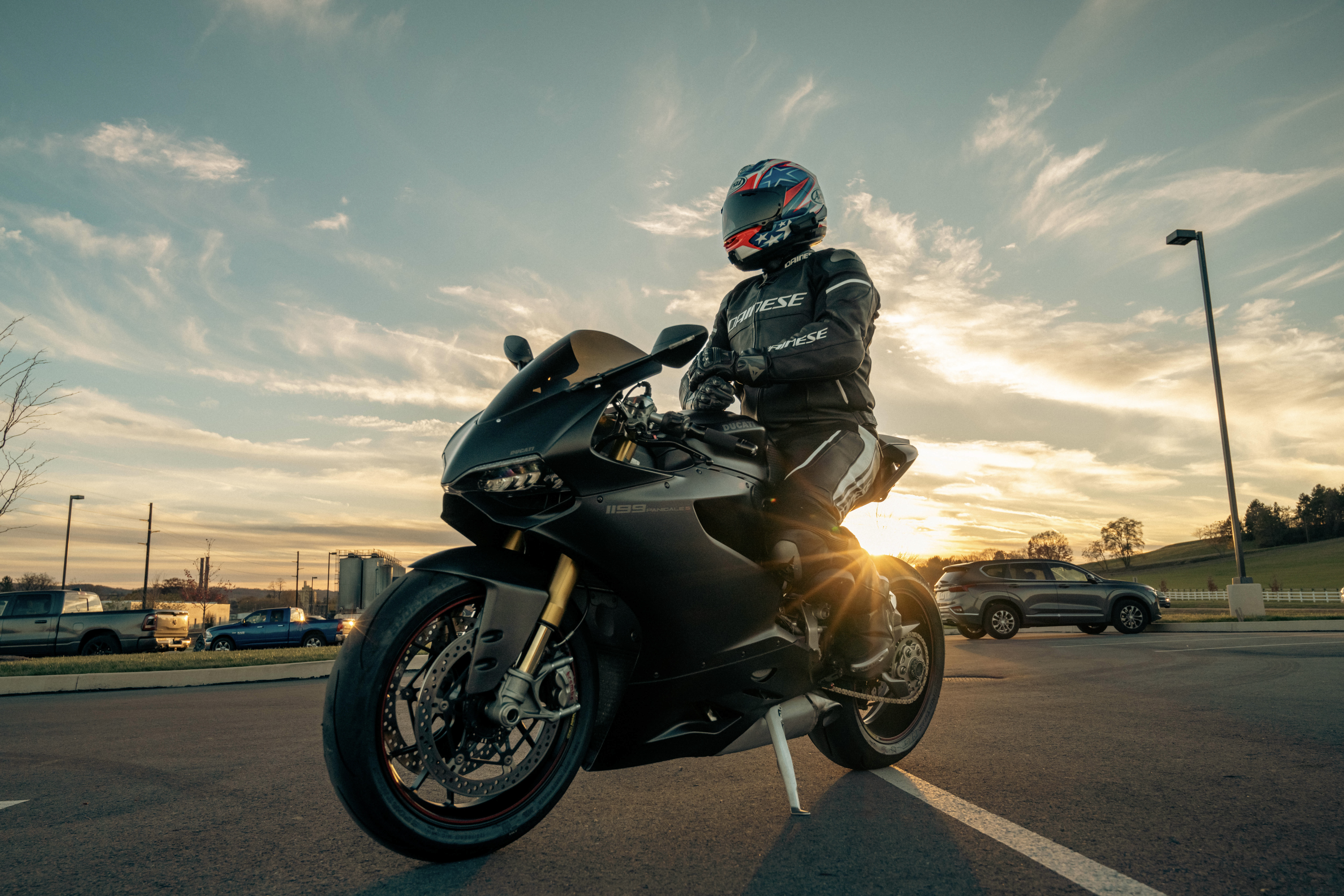 Photo of a person riding a motorcycle wearing a motorcycle helmet