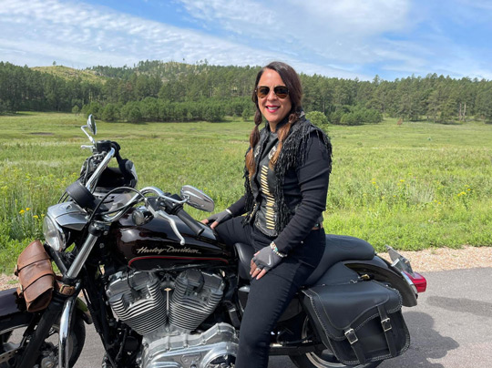 Photo of Dawn Givesi sitting on a motorcycle