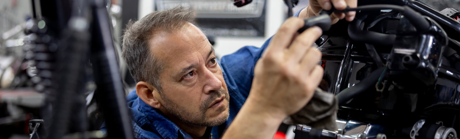 Photo of a person fixing a motorcycle