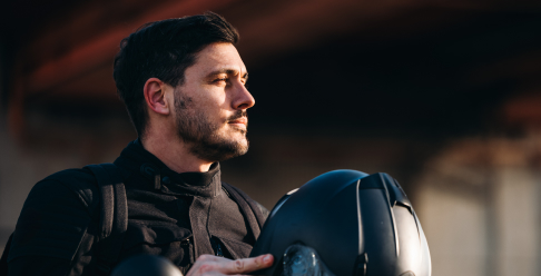 Photo of a person holding a motorcycle helmet