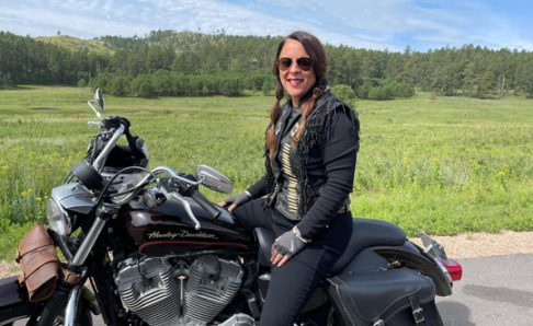 Dawn-Givesi-compressed Photo of Dawn Givesi sitting on a motorcycle